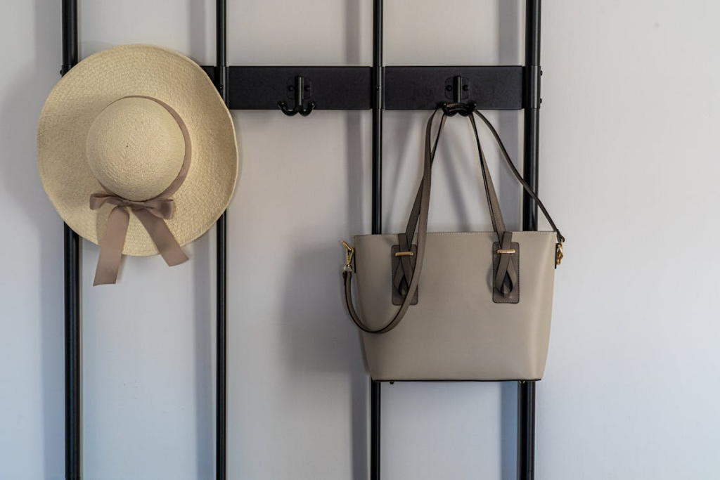 Minimal entryway with bag and hat hung neatly showing small organization habits