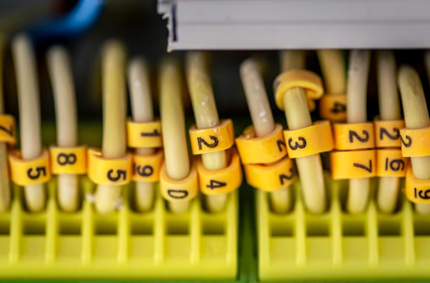 Close-up example of how to label cords and cables using numbered identification tags